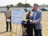 Assemblyman Rudy Salas speaks while Kings County Sheriff Dave Robinson looks on during a groundbreaking ceremony for a new sheriff's department building.